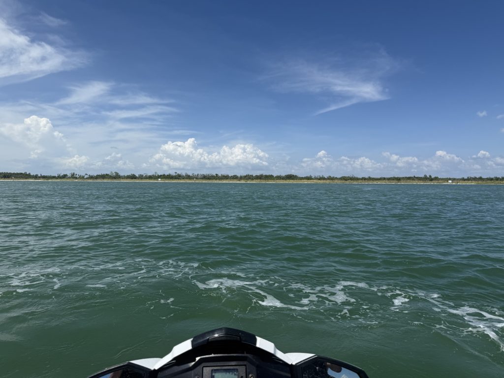 Jet skis cruising past the skyline and beaches of Tampa Bay.