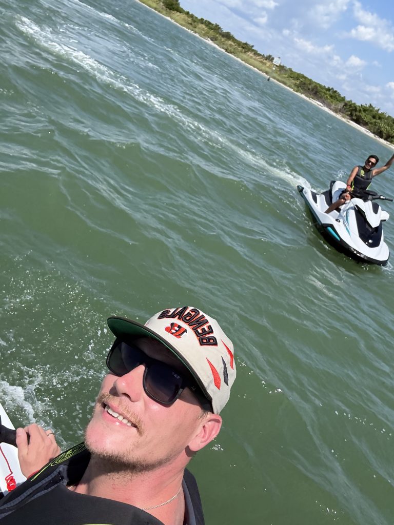 Family enjoying a sunny day riding jet skis in Tampa Bay.