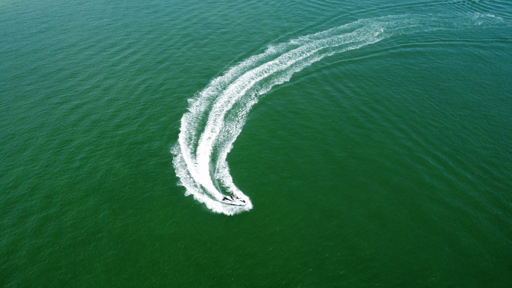 Jet skis cruising past the skyline and beaches of Tampa Bay.