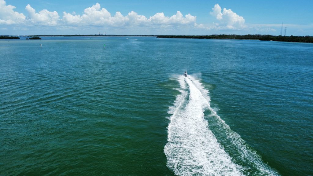 Jet skis cruising past the skyline and beaches of Tampa Bay.